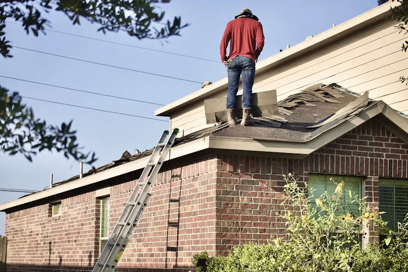 Professional roofer working on a residential roof in General Donovan